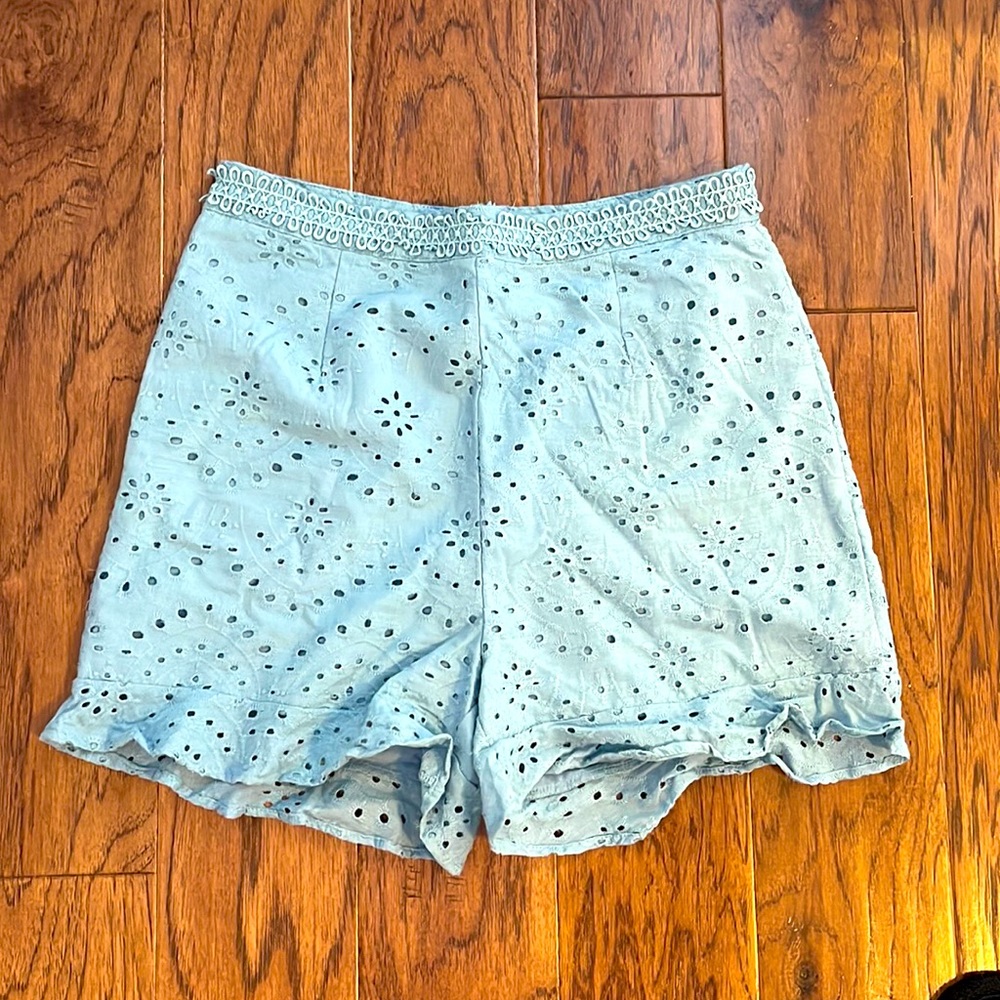 High rise eyelet shorts with bottom ruffle